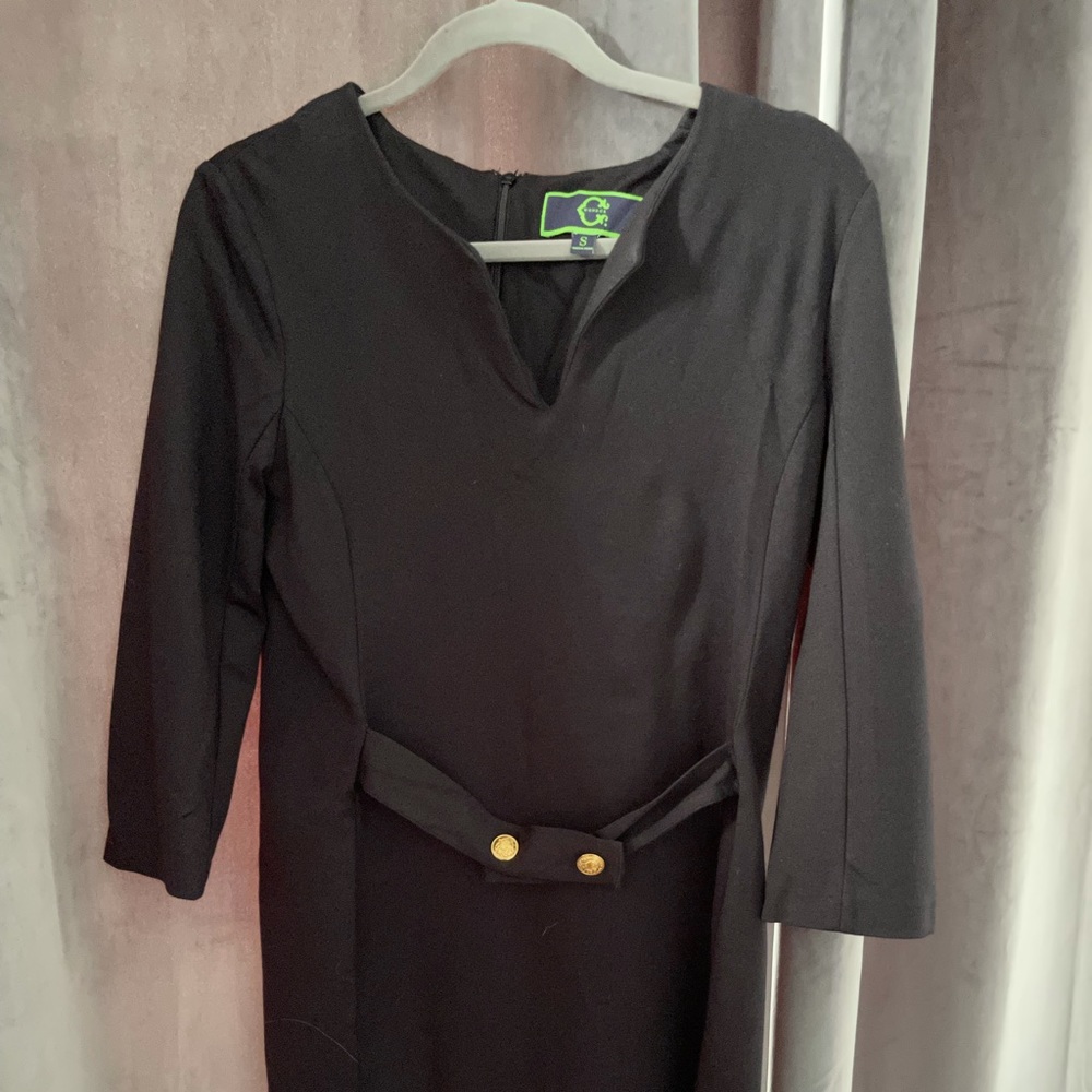 Black dress with gold button detail at waist